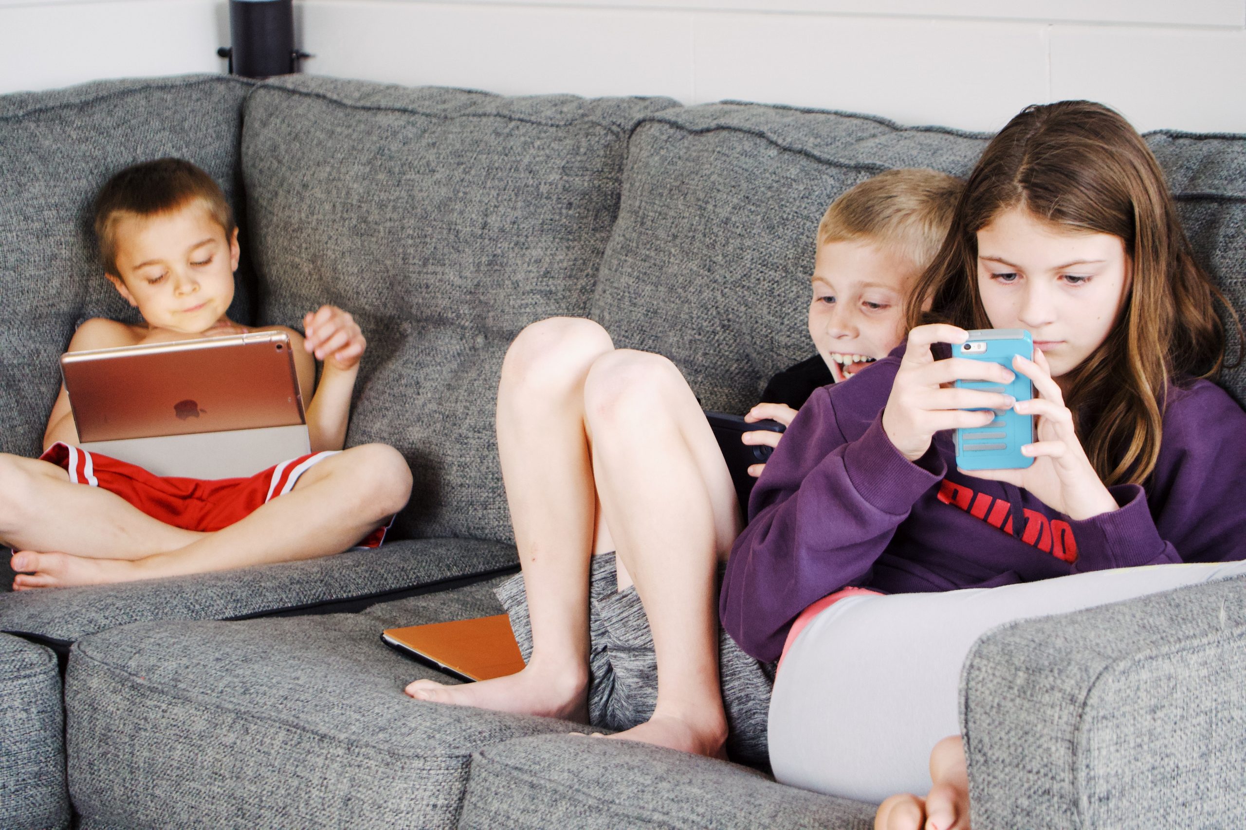 Mobile Games, Lootboxes, Kids playing on their phones on a couch
